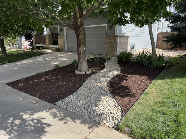 After: mulch beds with a winding river-rock path
